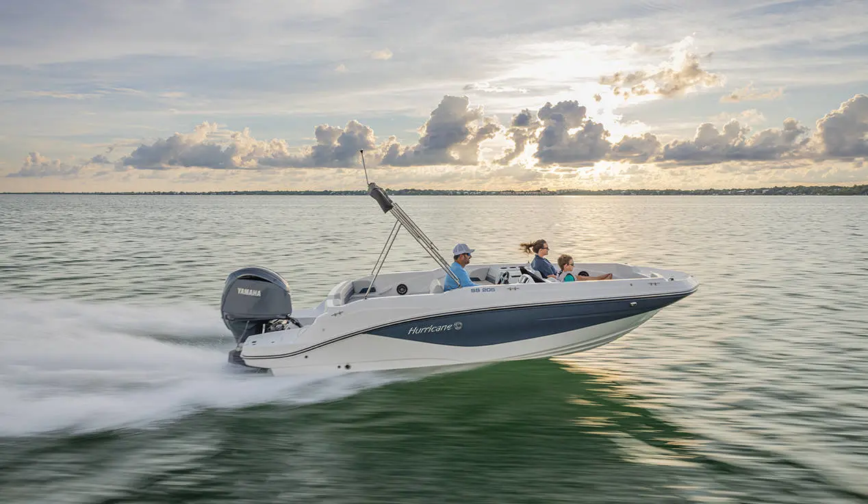 A family cruising the ocean on their Hurricane SunDeck Sport 205 OB deck boat.