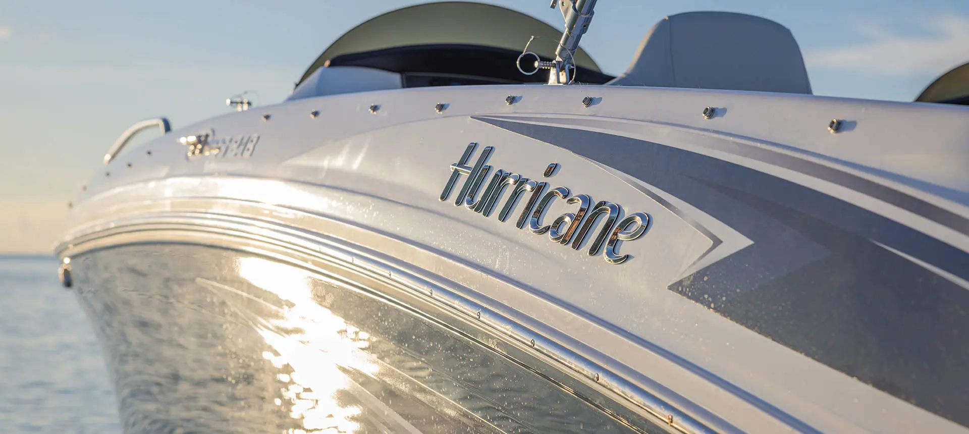 Closeup of the side of a Hurricane SunDeck Sport OB deck boat.