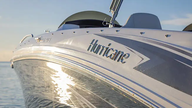 Closeup of the side of a Hurricane SunDeck Sport OB deck boat.
