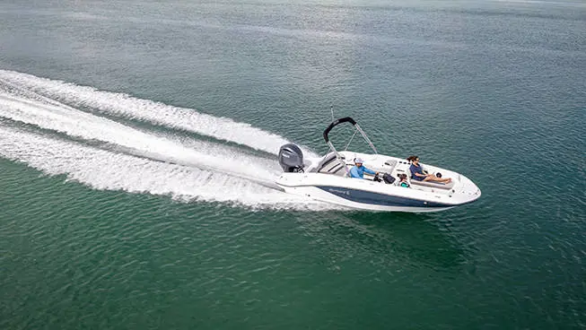 Aerial view of a Hurricane SunDeck Sport OB deck boat cruising across the ocean.