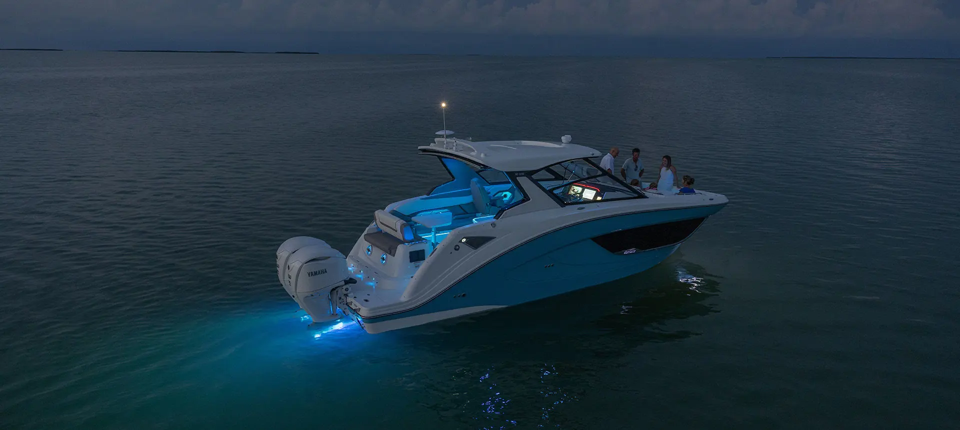 A Hurricane Yacht Certified boat showcasing the RGB full spectrum lighting while on the ocean at night.