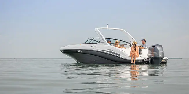 4 people relaxing on a Hurricane Yacht Certified boat while floating the ocean.