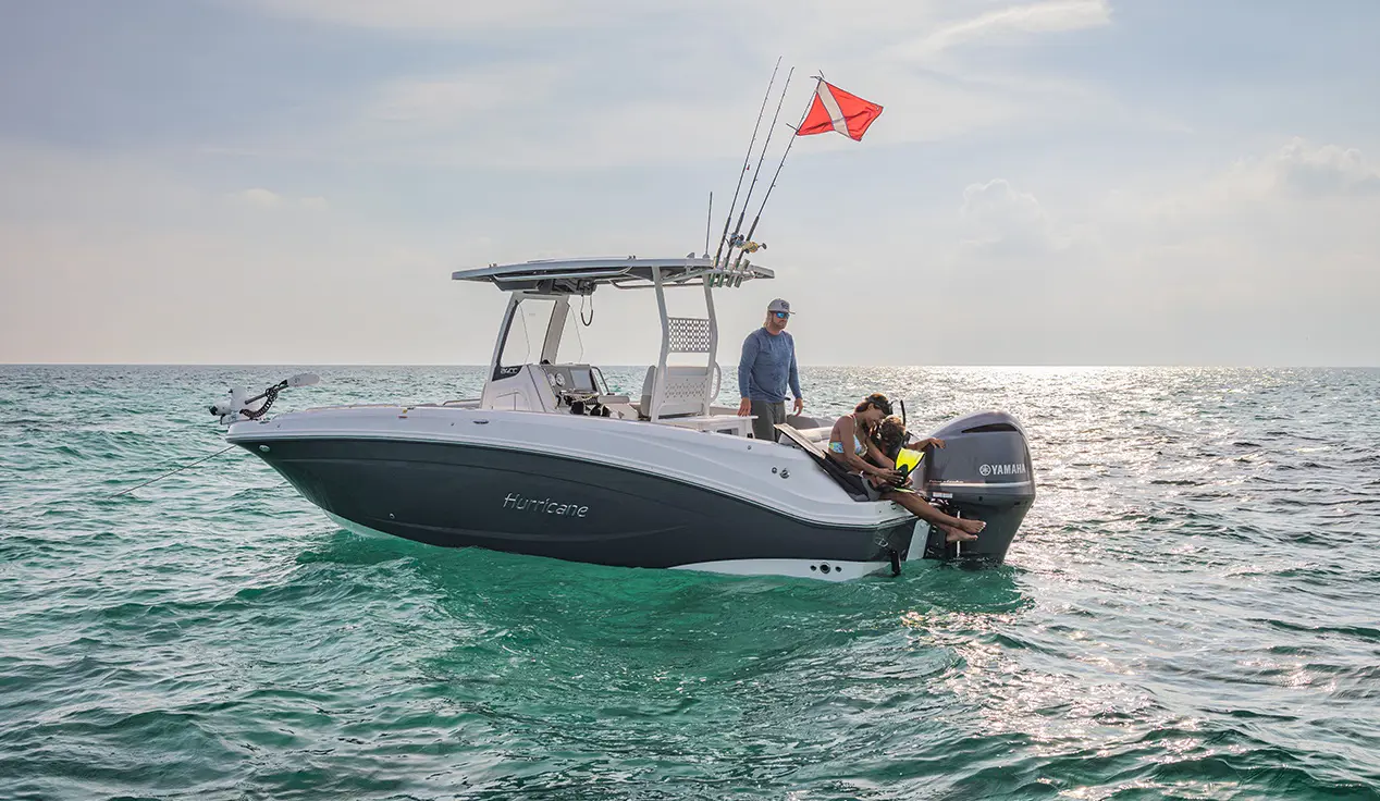 Family preparing to snorkle behind a Hurricane Outboard deck boat.