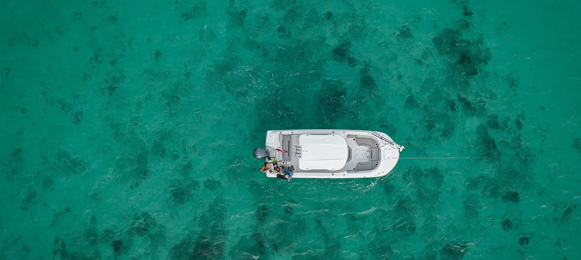 Overhead view of a parked Hurricane Outboard deck boat.