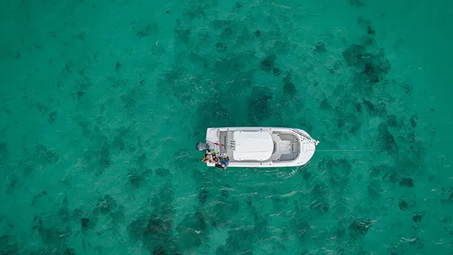 Overhead view of a parked Hurricane Outboard deck boat.