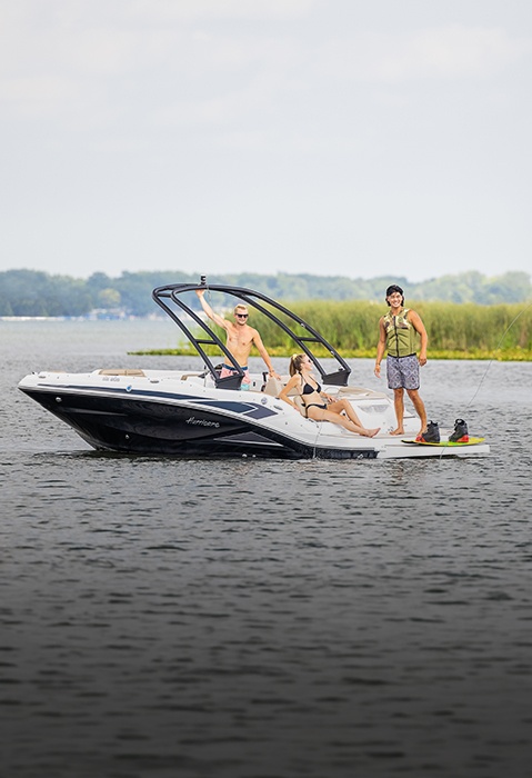 Family preparing to wakeboard behind a Hurricane sterndrive io boat.
