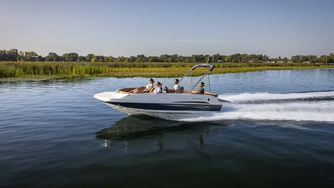 Hurricane sterndrive io boat speeding on lake.