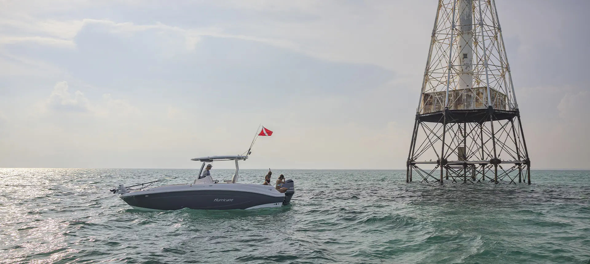 Snorkelers preparing to snorkel off the back of a parked Hurricane Center Console boat.