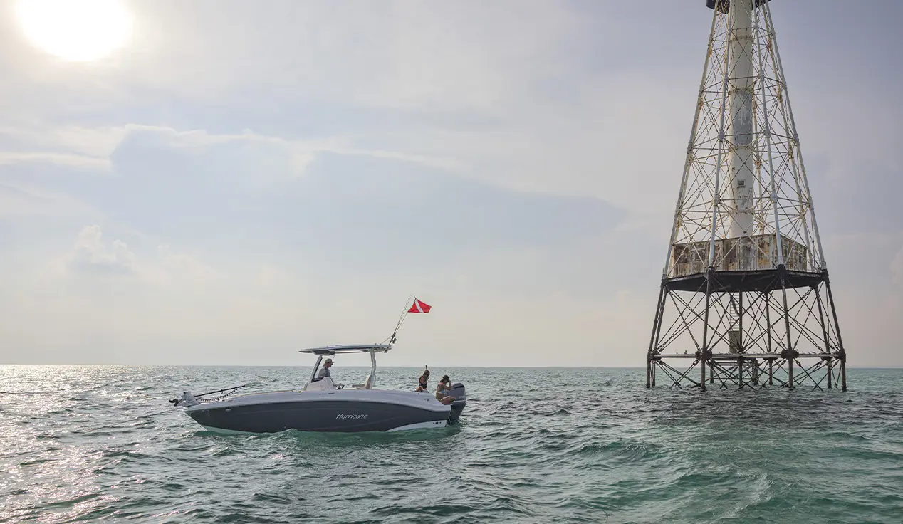 Snorkelers preparing to snorkel off the back of a parked Hurricane Center Console boat.