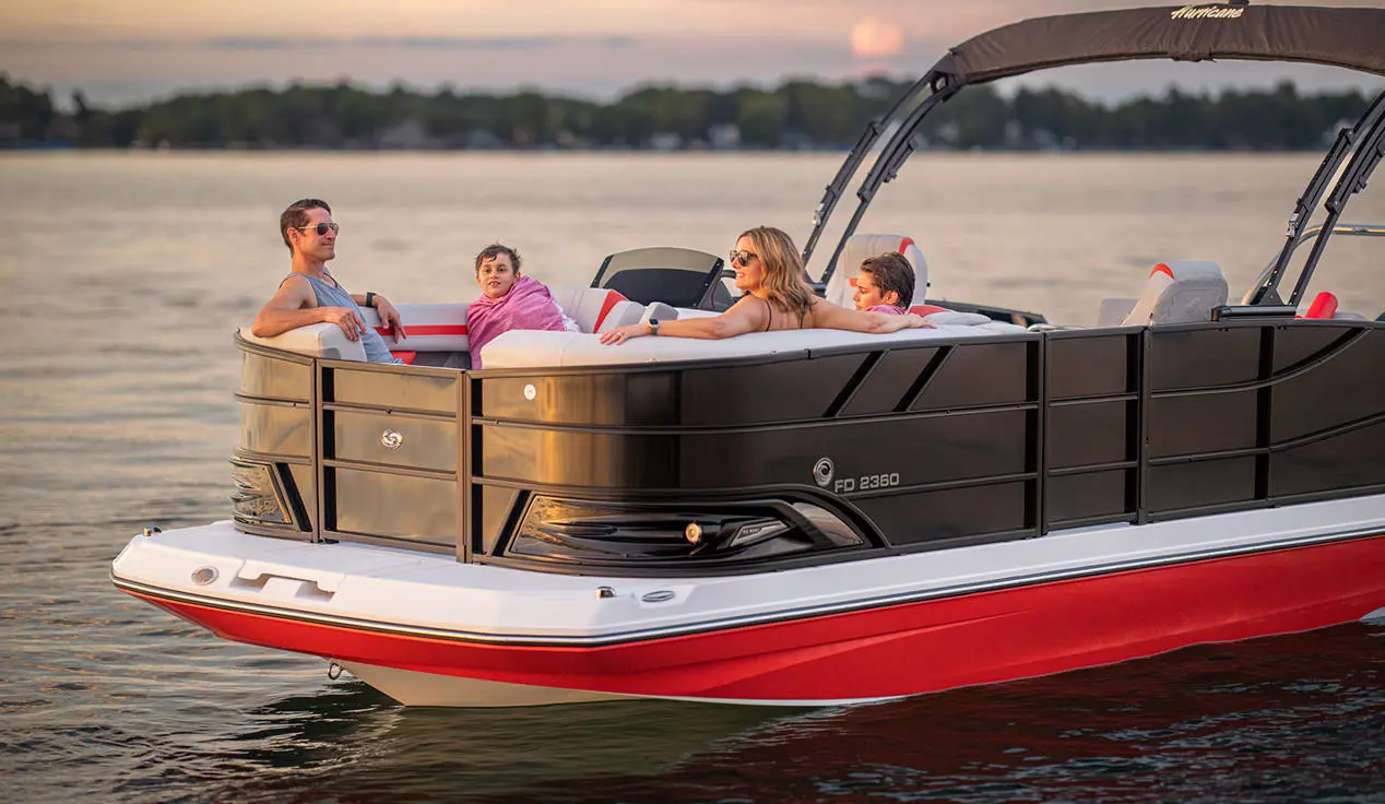 Family lounges in front seating of a Hurricane FunDeck boat.