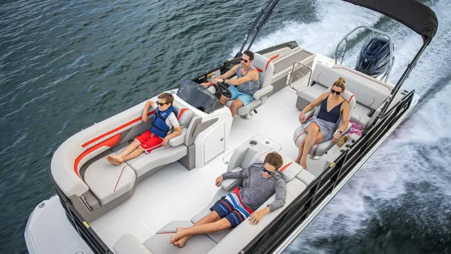 Overhead view of a family seated on a Hurricane FunDeck boat speeding across the water.