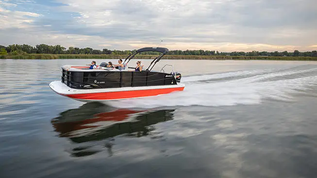 Black and red Hurricane FunDeck boat speeding across the water.