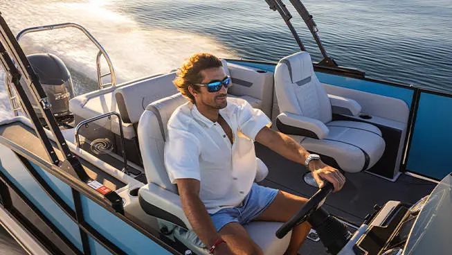 Man captains a Hurricane FunDeck boat.