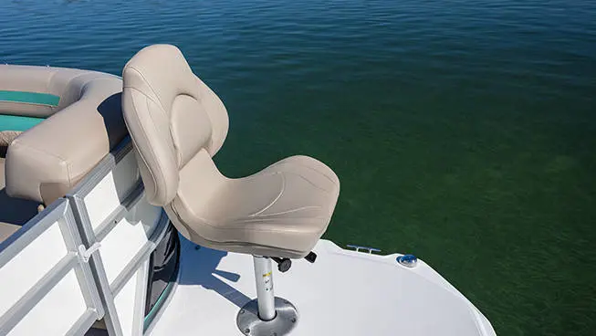 3 men fishing from a parked Hurricane FunDeck boat.