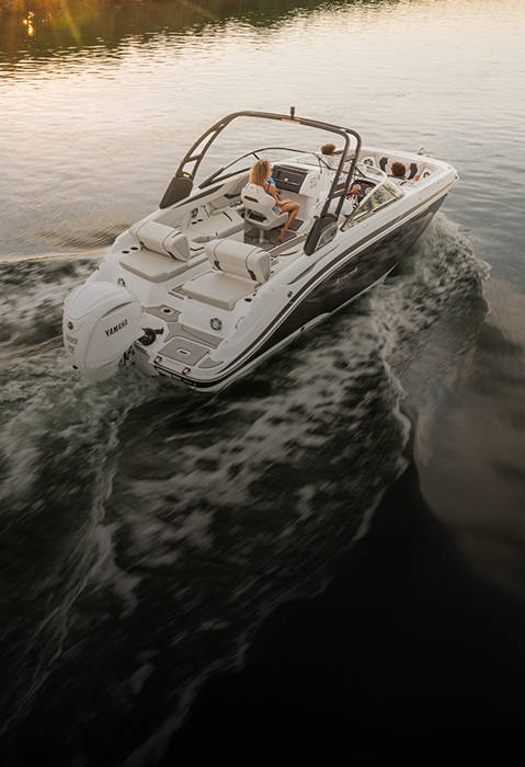 Overhead view of a Hurricane SunDeck 2600 Outboard boat cruising at sunset. 