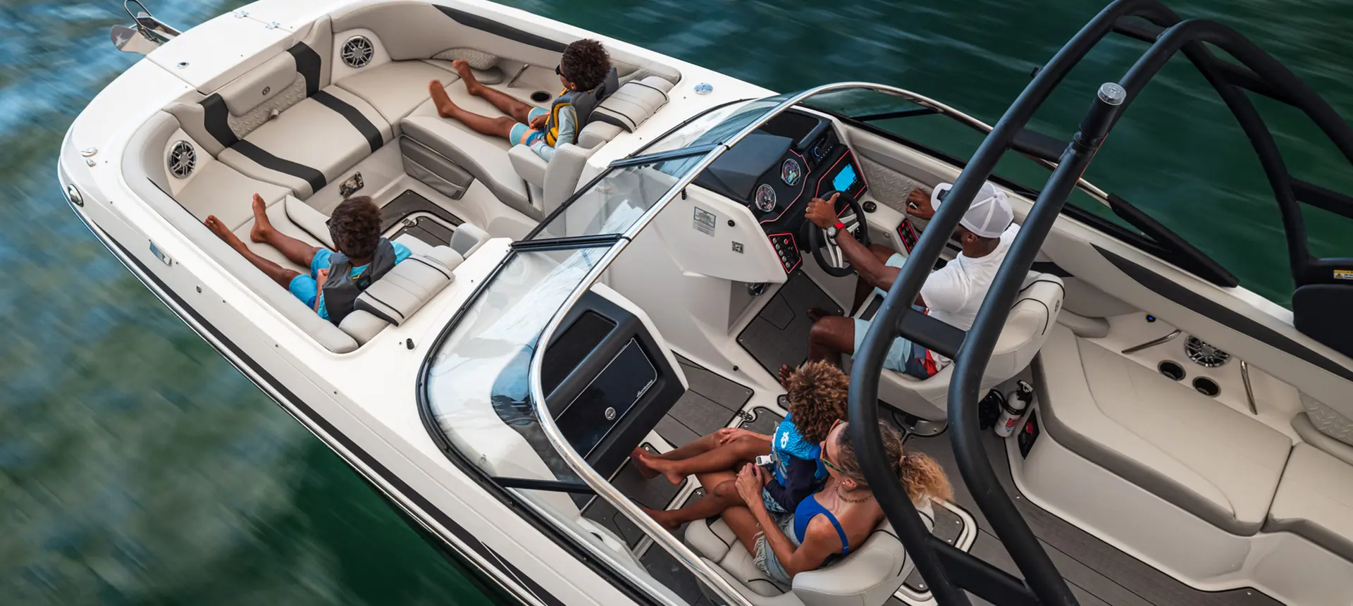 Overhead view of family riding in Hurricane SunDeck 2600 Outboard boat.