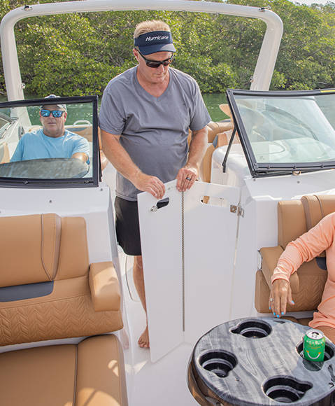 Walk through bi-fold doors on a Hurricane SunDeck 2690 Outboard boat. 