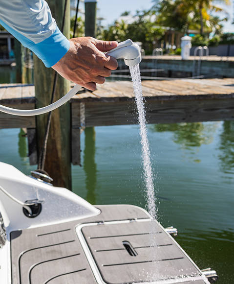 Built-in stern washdown on a Hurricane SunDeck 2690 Outboard boat. 