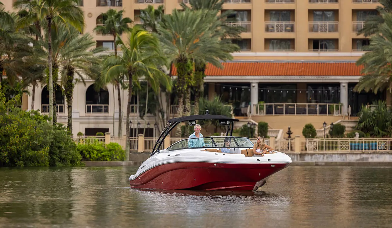 Friends curise through bay on a Hurricane SunDeck 2690 Outboard boat.