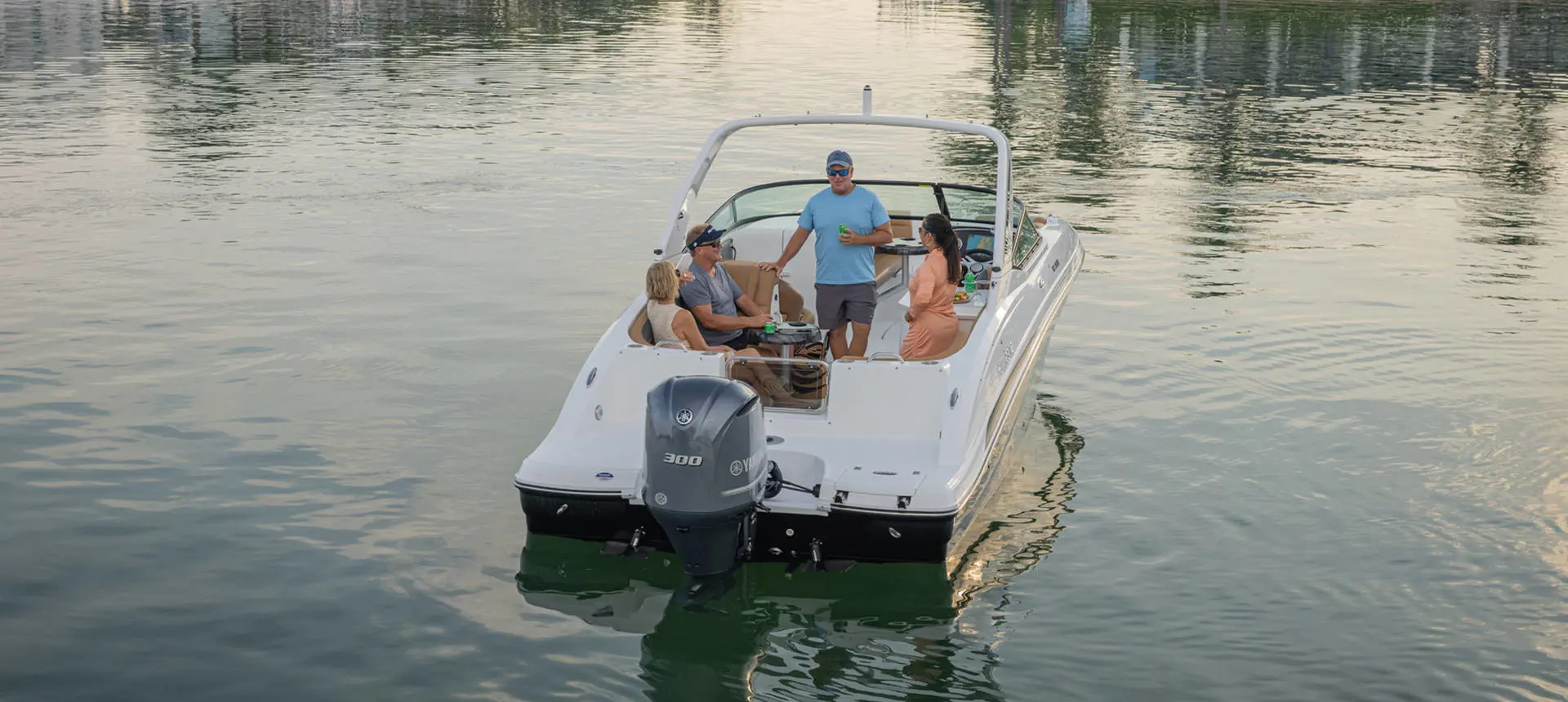 Rear-end view of friends lounging on a Hurricane SunDeck 2690 Outboard boat.