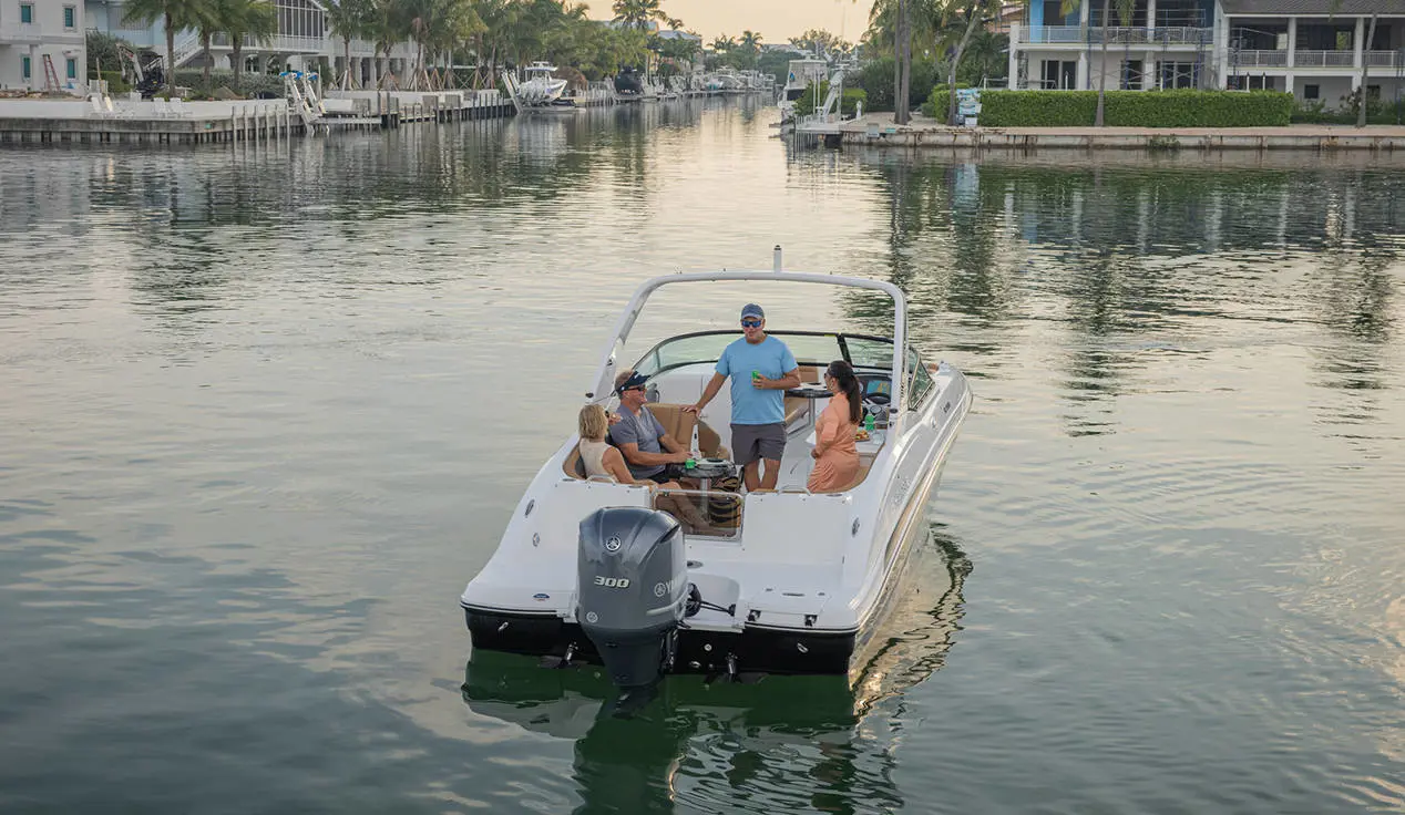 Rear-end view of friends lounging on a Hurricane SunDeck 2690 Outboard boat.