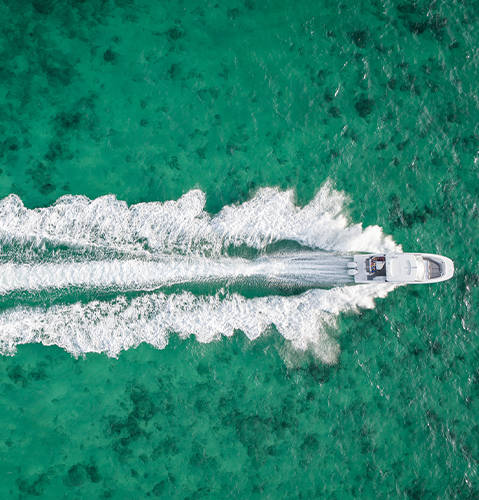 Overhead view of a Hurricane 3200 Outboard boat speeding across the water. 