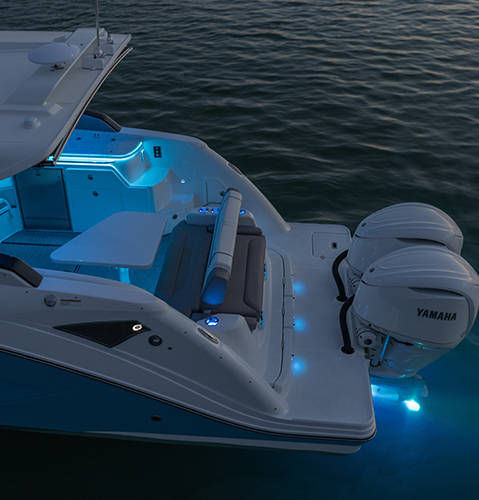 Hurricane 3200 Outboard boat lit up with RGB lighting system. 