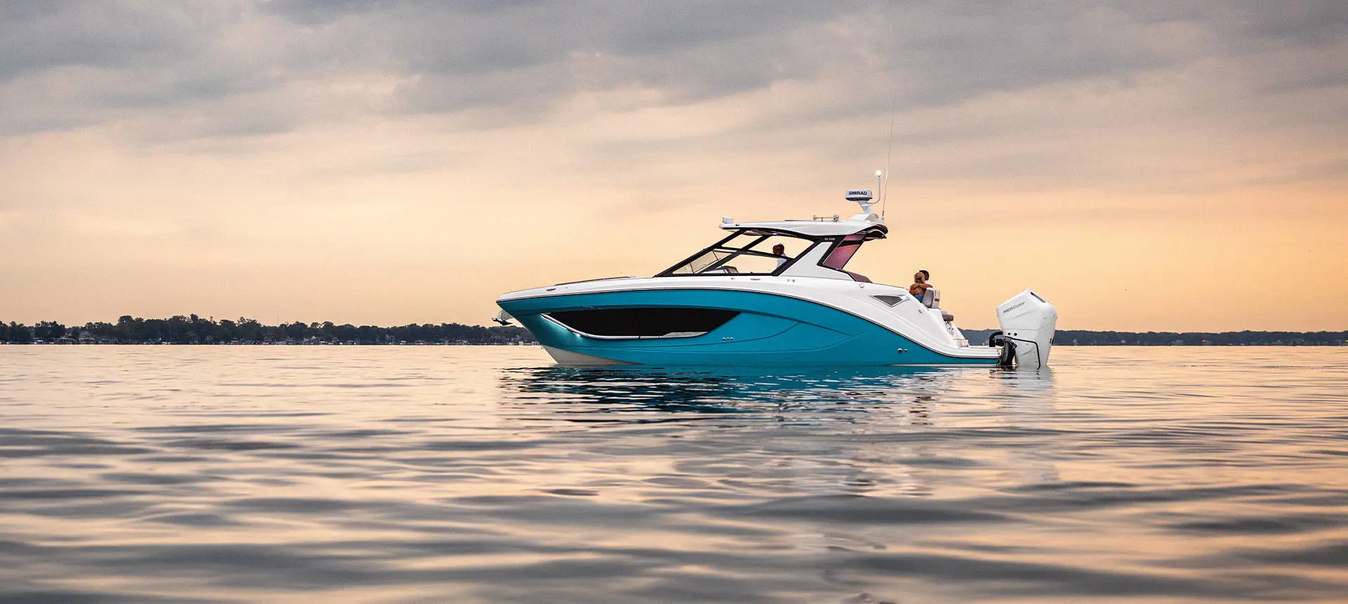 Side view of a Hurricane 3200 Outboard boat parked on the water.