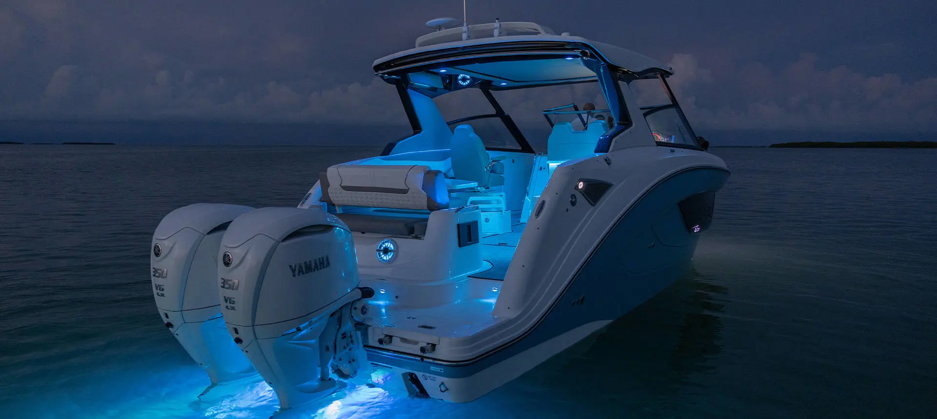 Hurricane 3200 Outboard boat with RGB lighting on the water.