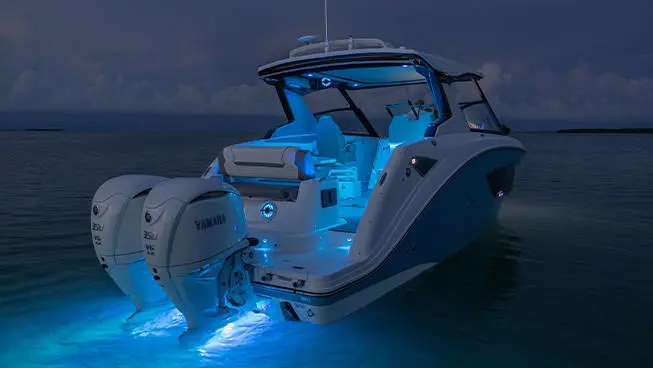Hurricane 3200 Outboard boat with RGB lighting on the water.