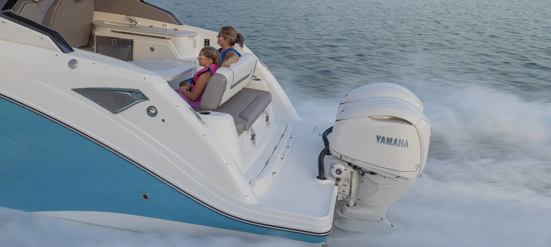 Mother and daugher in rear seating of a Hurricane 3200 Outboard boat.