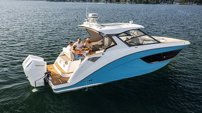 Friends enjoying snacks from rear seating on a Hurricane 3200 Outboard boat.