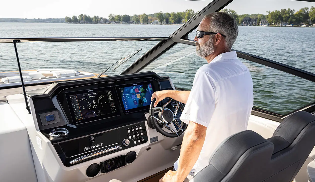 Man captains a Hurricane 3200 Outboard boat.