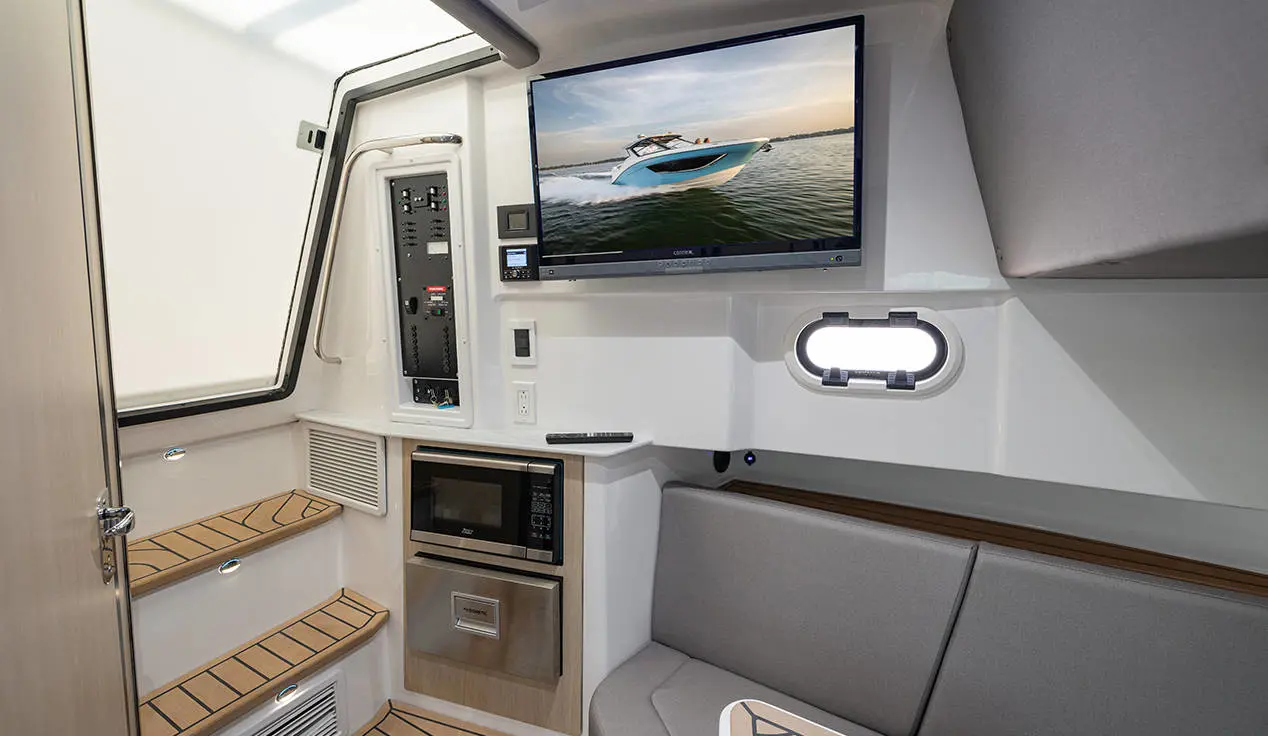 TV, microwave, and in-cabin seating on a Hurricane 3200 Outboard boat.