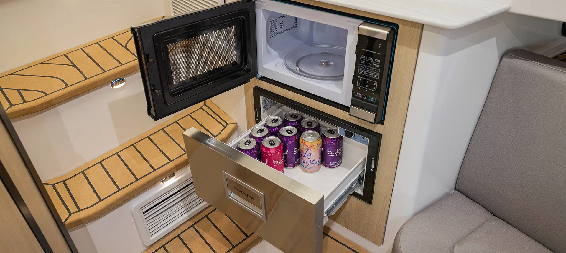 Opened Fridge and microwave on a Hurricane 3200 Outboard boat.