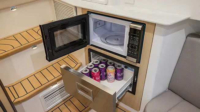 Opened Fridge and microwave on a Hurricane 3200 Outboard boat.