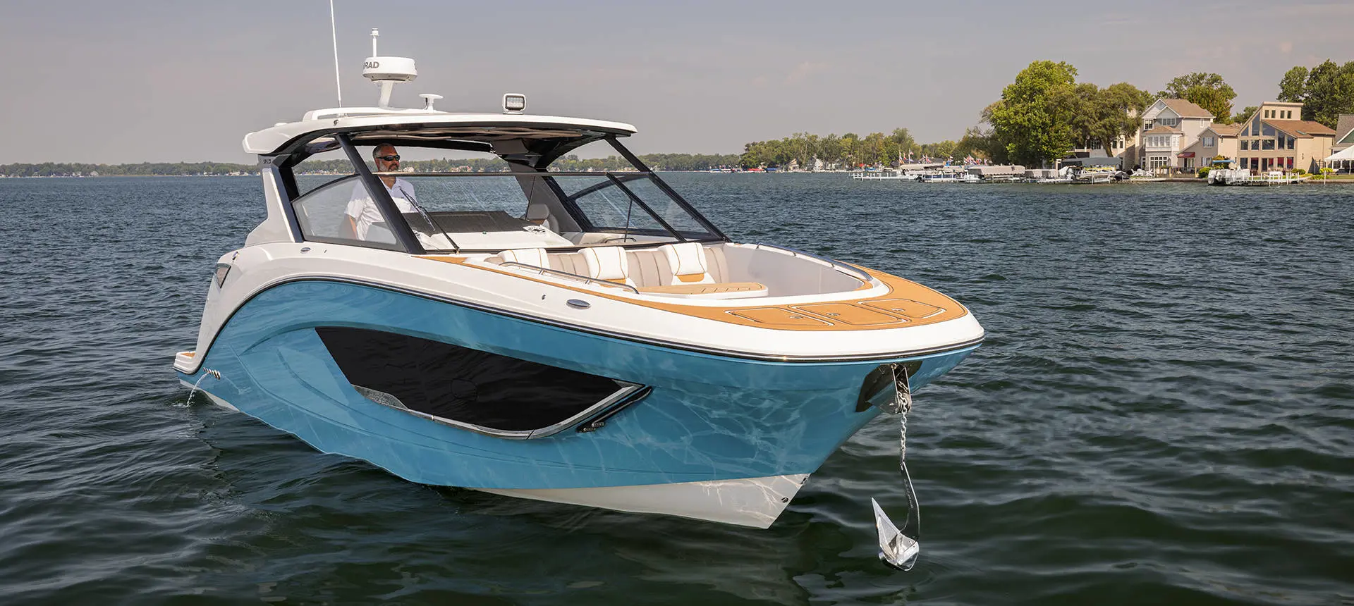 Man lowering anchor on a Hurricane 3200 Outboard boat.
