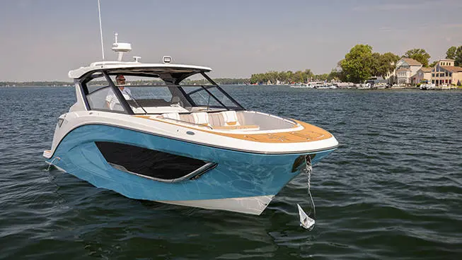 Man lowering anchor on a Hurricane 3200 Outboard boat.