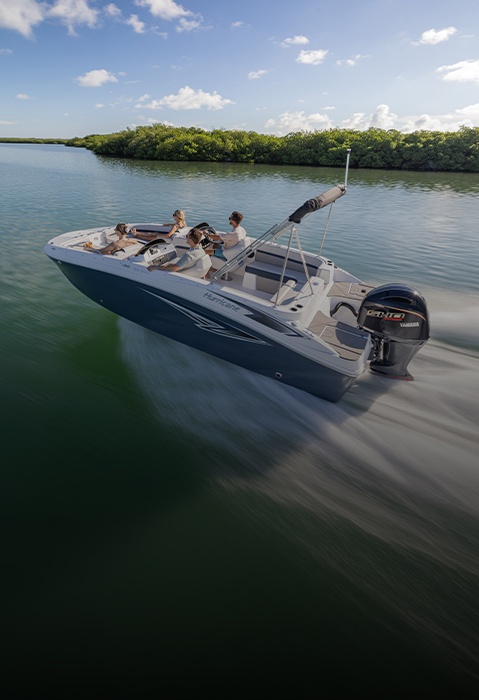 Hurricane SunDeck Sport boat cruising across the water.