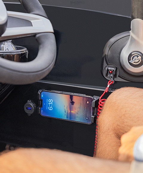 Wireless charging port on a Hurricane SunDeck Sport boat.