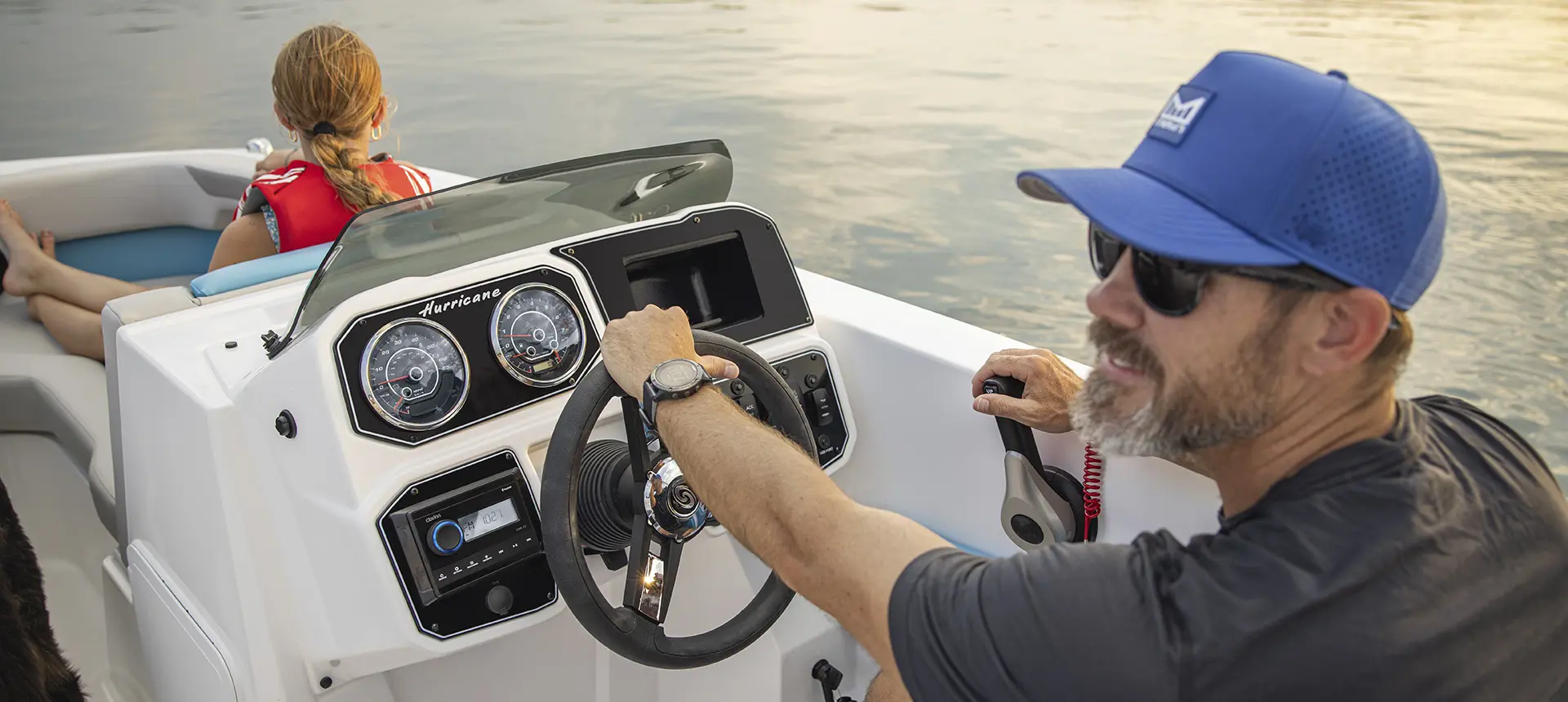 Captain driving a Hurricane SunDeck Sport boat.