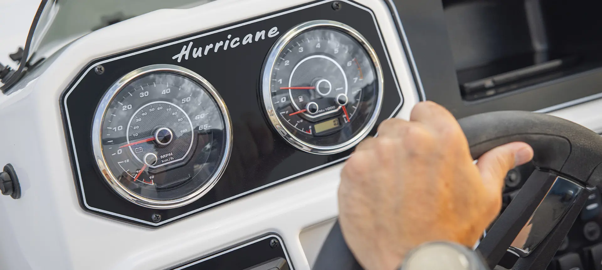 Speedometer details on a Hurricane SunDeck Sport boat.