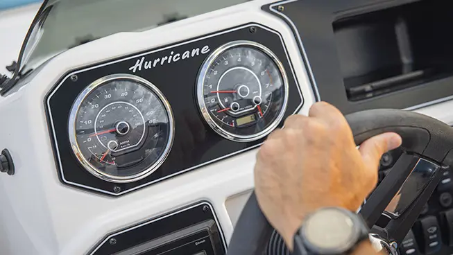 Speedometer details on a Hurricane SunDeck Sport boat.
