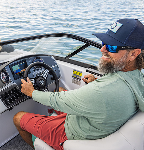 Captain seated in premium helm on a  Hurricane Sundeck boat.