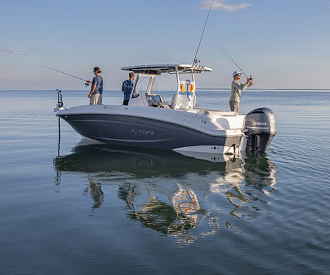 3 friends fishing off of open-layout Hurricane fishing boat. 