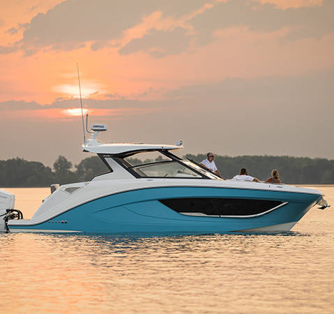 Friends parked in a Hurricane Yacht Certified boat at sunset.