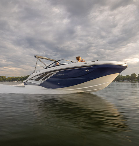 Parked Hurricane Sundeck boat on the water. 