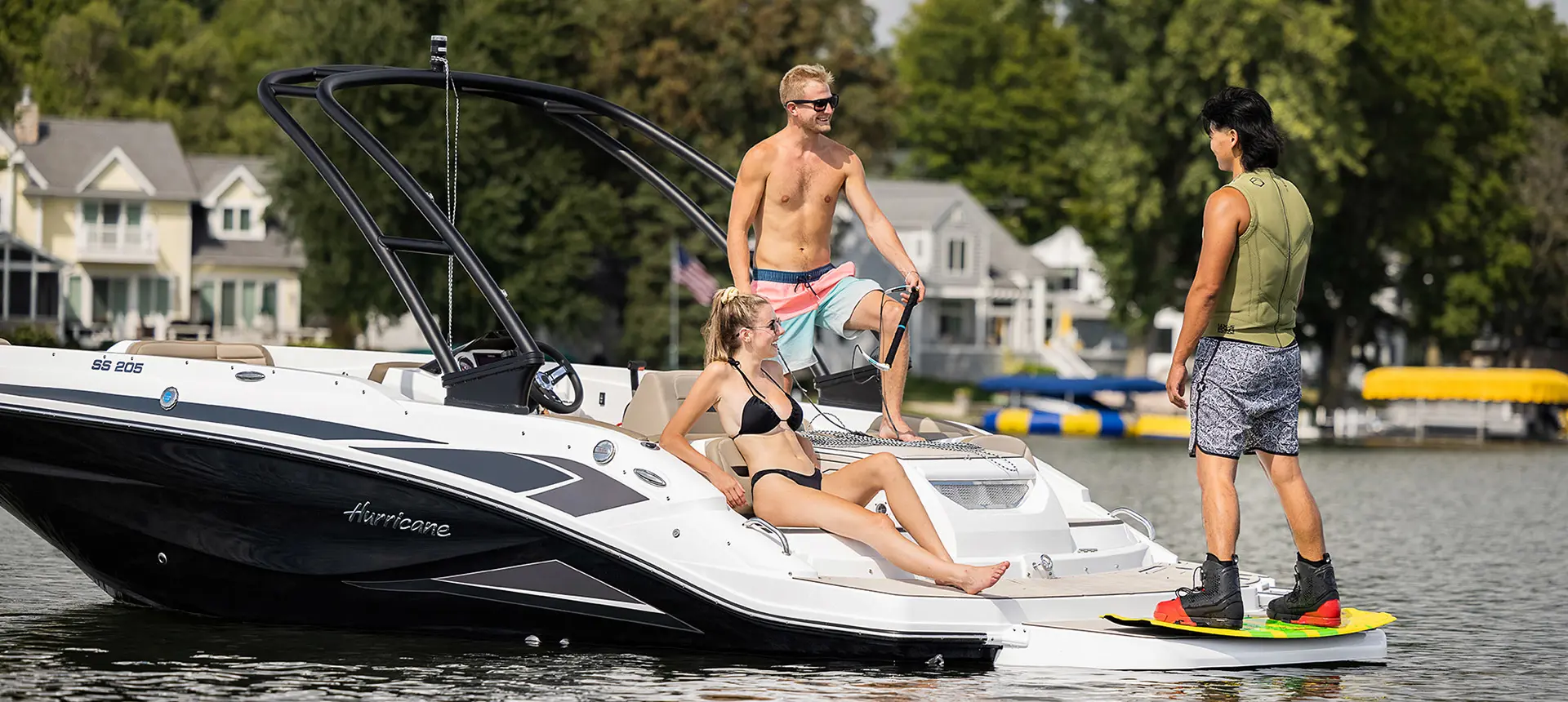 Three friends chatting next to their Hurricane boat