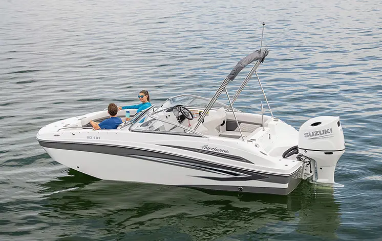 A happy couple sailing the water on their boat