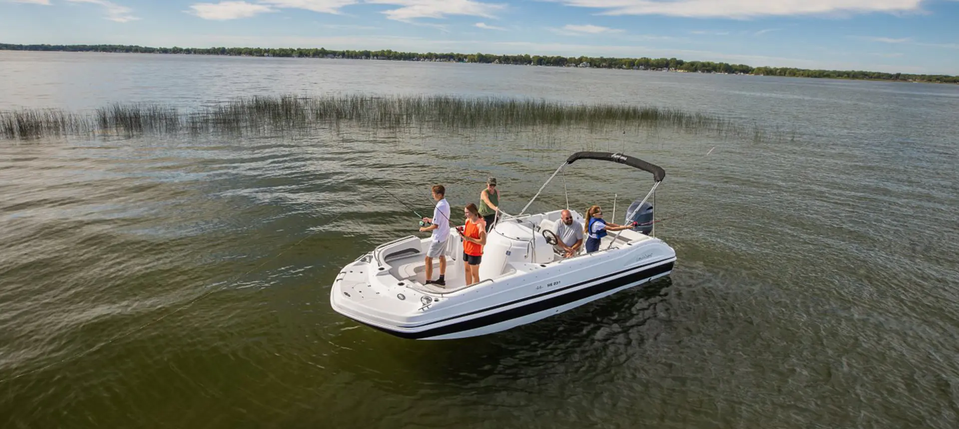 family fishing off all ends of a hurricane boat